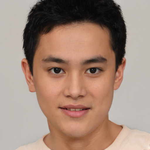 Joyful asian young-adult male with short  brown hair and brown eyes