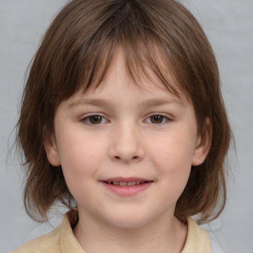 Joyful white child female with medium  brown hair and brown eyes