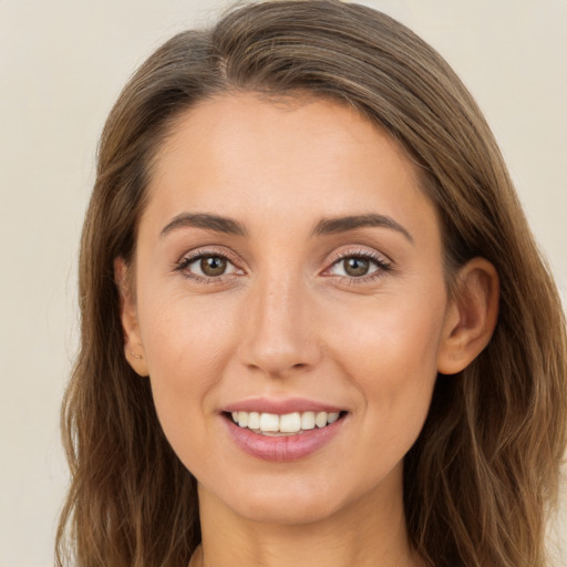 Joyful white young-adult female with long  brown hair and brown eyes