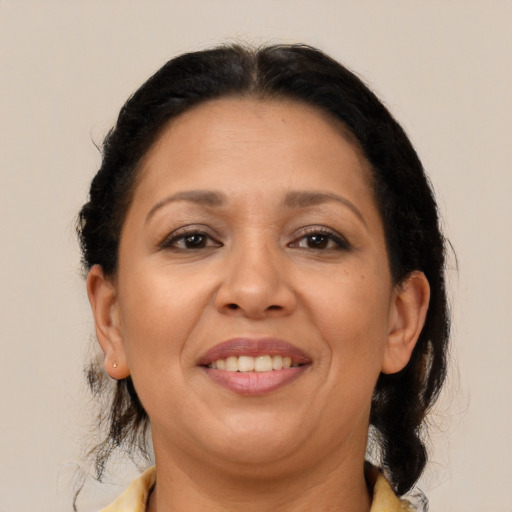 Joyful latino adult female with medium  brown hair and brown eyes