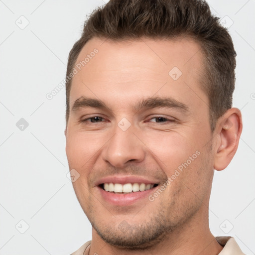 Joyful white young-adult male with short  brown hair and brown eyes