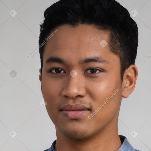 Joyful latino young-adult male with short  black hair and brown eyes