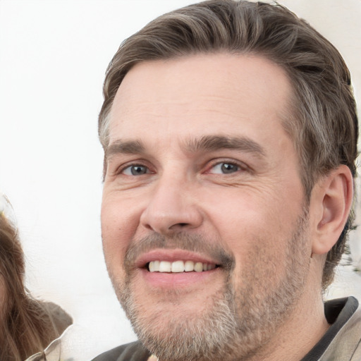 Joyful white adult male with short  brown hair and grey eyes