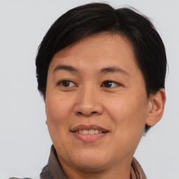 Joyful asian adult female with short  brown hair and brown eyes