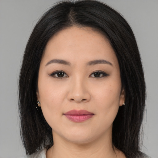 Joyful asian young-adult female with long  black hair and brown eyes
