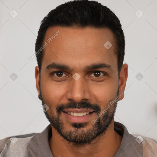 Joyful latino young-adult male with short  black hair and brown eyes