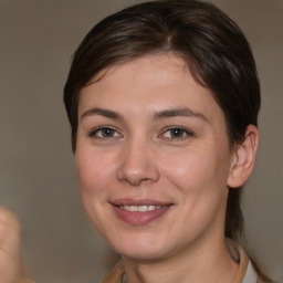 Joyful white young-adult female with medium  brown hair and brown eyes