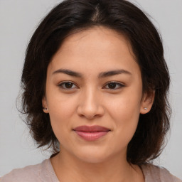 Joyful asian young-adult female with medium  brown hair and brown eyes