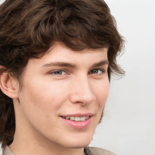 Joyful white young-adult male with medium  brown hair and grey eyes