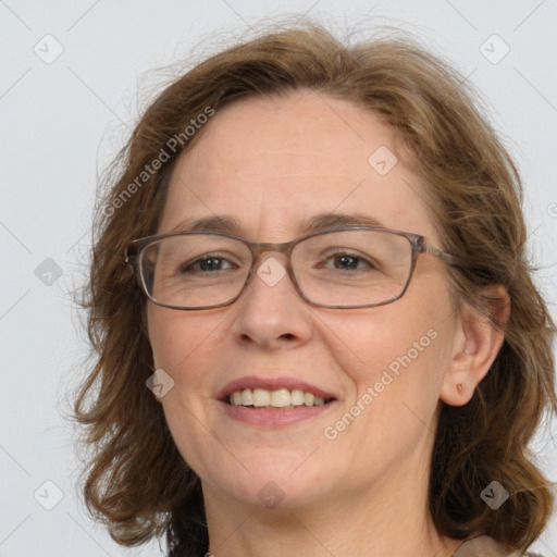 Joyful white adult female with long  brown hair and green eyes