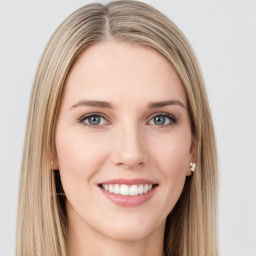 Joyful white young-adult female with long  brown hair and green eyes