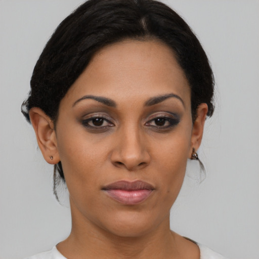 Joyful black young-adult female with medium  brown hair and brown eyes