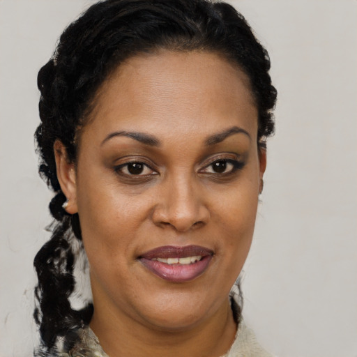Joyful black adult female with short  brown hair and brown eyes