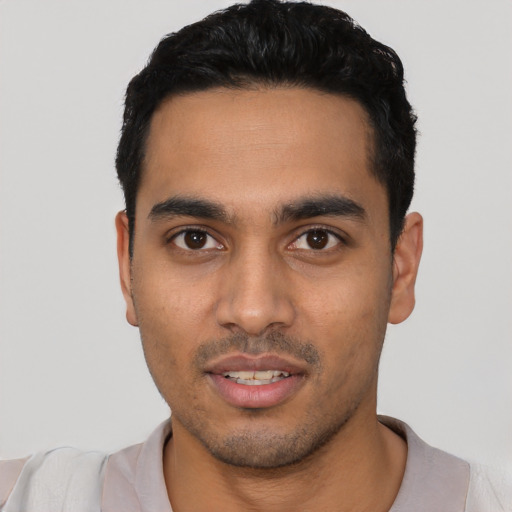 Joyful latino young-adult male with short  black hair and brown eyes