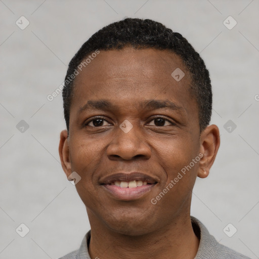 Joyful black young-adult male with short  black hair and brown eyes