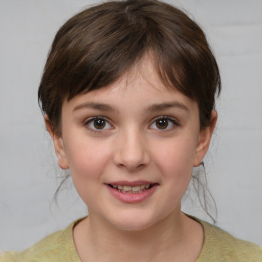 Joyful white child female with medium  brown hair and brown eyes