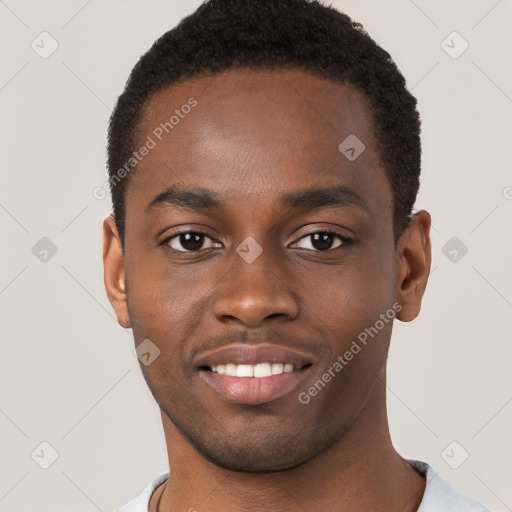 Joyful black young-adult male with short  brown hair and brown eyes