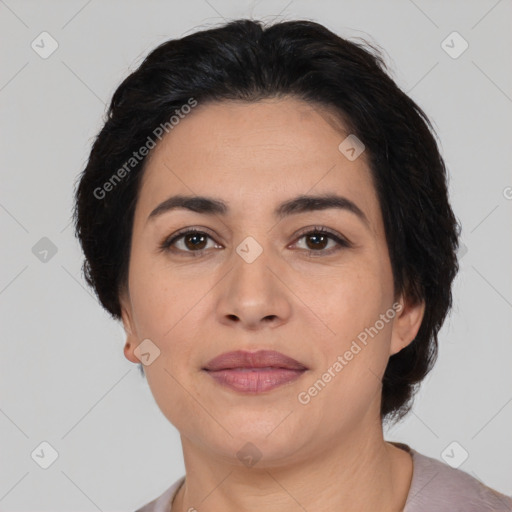 Joyful latino adult female with medium  brown hair and brown eyes