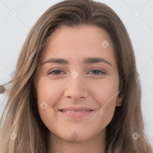 Joyful white young-adult female with long  brown hair and brown eyes