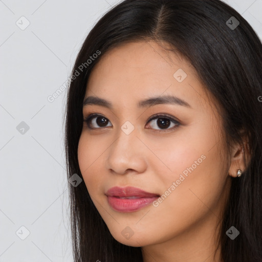 Joyful asian young-adult female with long  brown hair and brown eyes