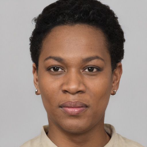 Joyful black young-adult female with short  black hair and brown eyes