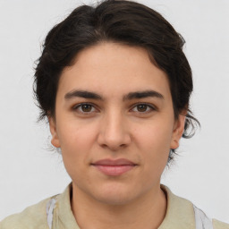 Joyful white young-adult female with medium  brown hair and brown eyes