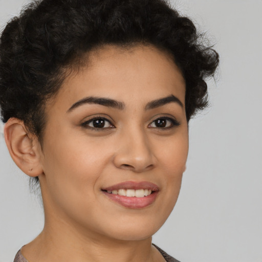 Joyful latino young-adult female with short  brown hair and brown eyes