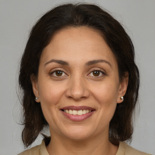 Joyful white adult female with medium  brown hair and brown eyes