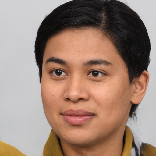 Joyful asian young-adult male with medium  brown hair and brown eyes