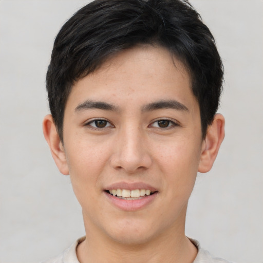 Joyful asian young-adult male with short  brown hair and brown eyes