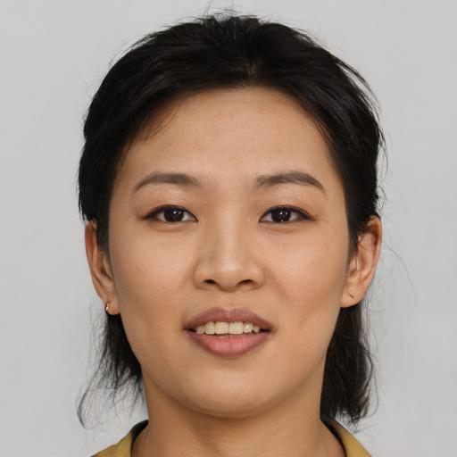 Joyful asian young-adult female with medium  black hair and brown eyes