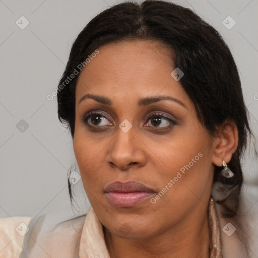 Joyful latino adult female with medium  brown hair and brown eyes