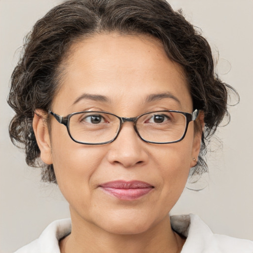 Joyful white adult female with medium  brown hair and brown eyes