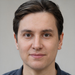 Joyful white adult male with short  brown hair and grey eyes