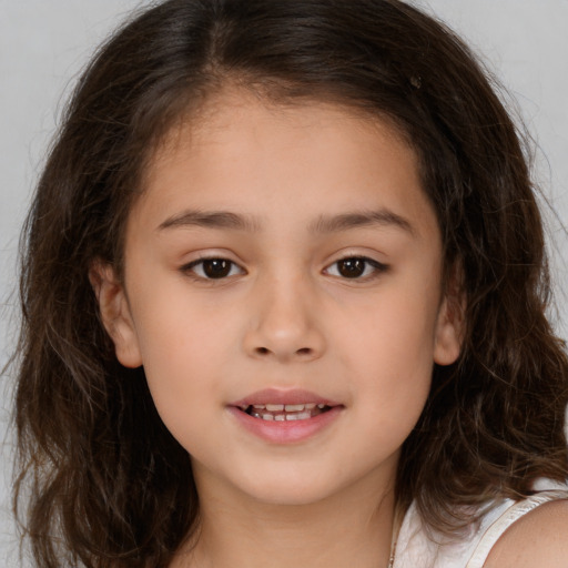 Joyful white child female with medium  brown hair and brown eyes