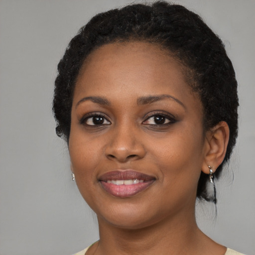 Joyful black young-adult female with medium  black hair and brown eyes