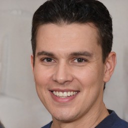 Joyful white adult male with short  brown hair and brown eyes