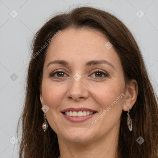 Joyful white adult female with long  brown hair and grey eyes