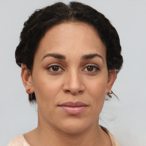 Joyful latino adult female with short  brown hair and brown eyes