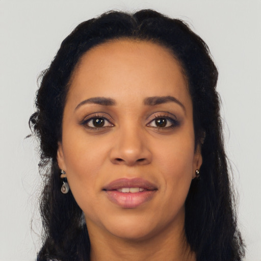 Joyful black young-adult female with long  black hair and brown eyes