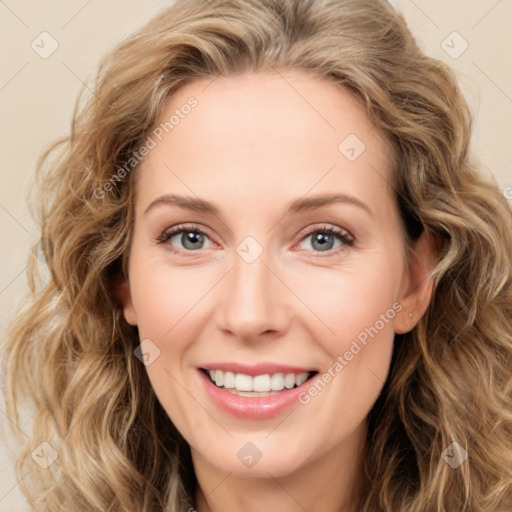 Joyful white young-adult female with long  brown hair and green eyes