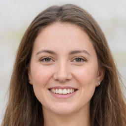 Joyful white young-adult female with long  brown hair and grey eyes