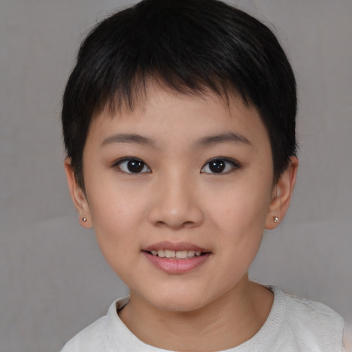 Joyful asian child female with short  brown hair and brown eyes