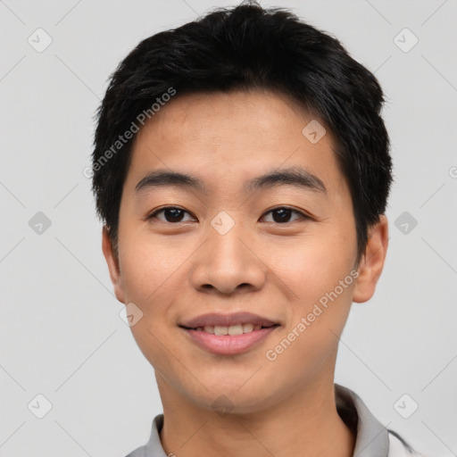 Joyful asian young-adult male with short  black hair and brown eyes