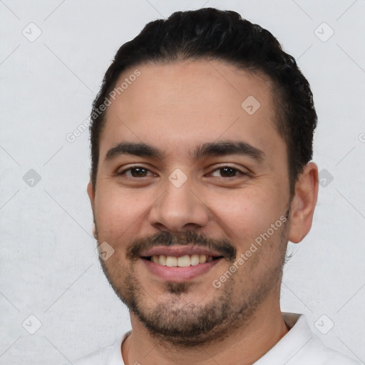 Joyful white young-adult male with short  black hair and brown eyes