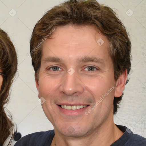 Joyful white adult male with medium  brown hair and brown eyes