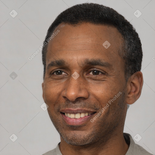 Joyful black adult male with short  black hair and brown eyes