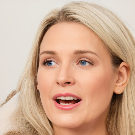 Joyful white young-adult female with long  brown hair and blue eyes