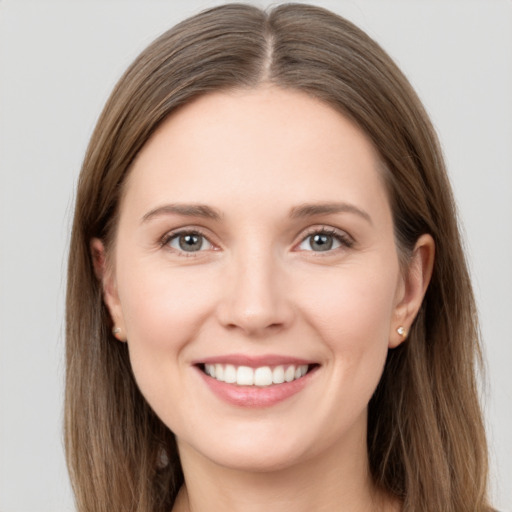 Joyful white young-adult female with long  brown hair and grey eyes