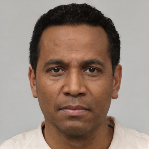 Neutral latino adult male with short  black hair and brown eyes